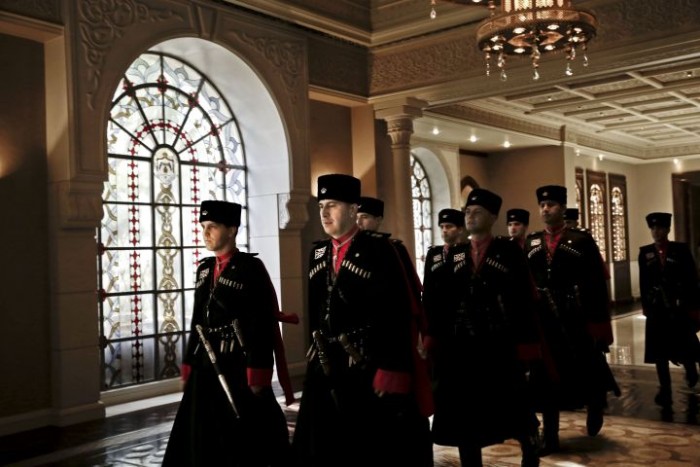 Circassian guards march inside Basman Palace in Amman, Jordan, on Jan 11, 2016. Their unique uniforms include 16 decorative rifle cartridges. Traditionally, one cartridge held poison for suicide if they were captured or for pouring into a slot on their sword.