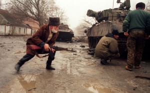 A Chechen volunteer, left, takes cover behind a Russian tank in 1995 during street fighting in Grozny opposing Russian troops.Oleg Nikishin/AFP/Getty Images